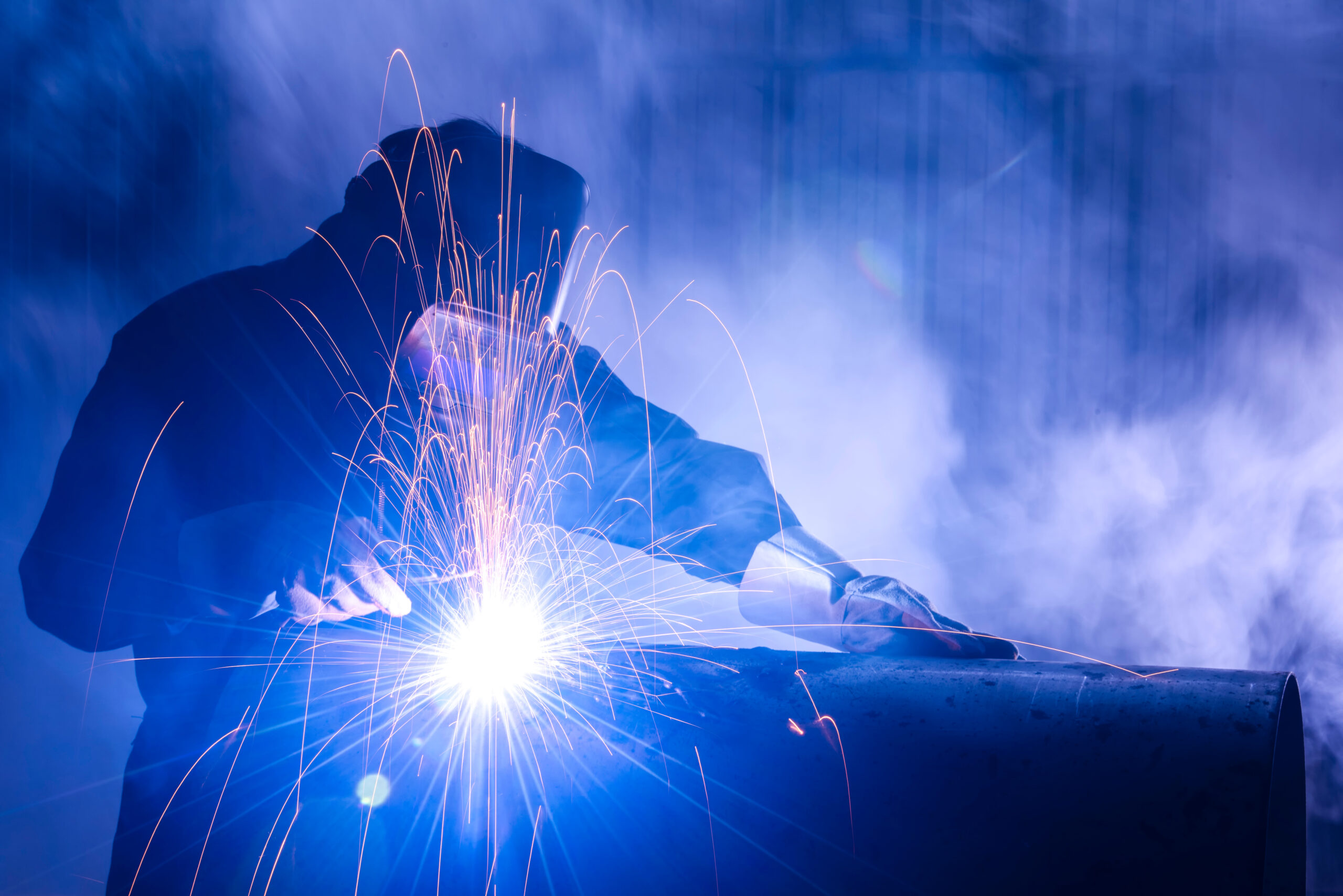 Industrial welders, industrial steel pipe parts, welding workers, steel workpieces